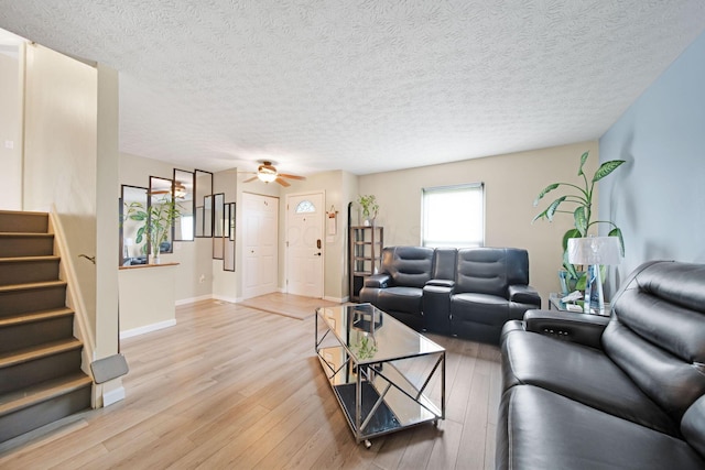 5309 Trillium Ct, Columbus, OH 43230 - living room with stairway, light wood finished floors, a ceiling fan, a textured ceiling, and baseboards
