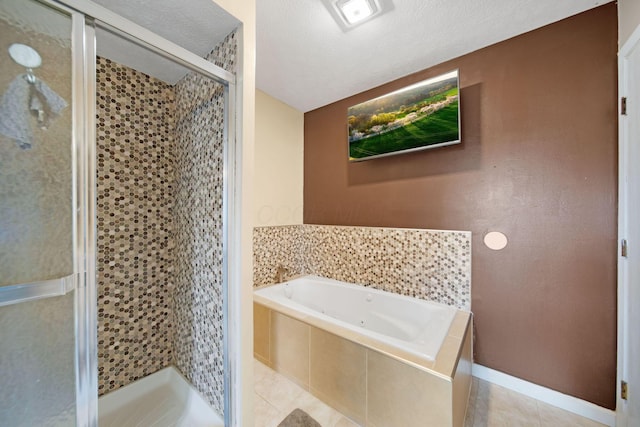 5309 Trillium Ct, Columbus, OH 43230 - full bath with a shower stall, a tub with jets, tile patterned floors, baseboards, and a textured ceiling
