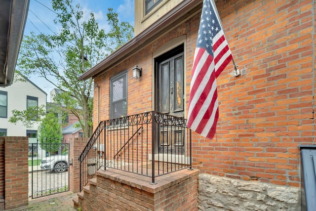 606 S 9th St, Columbus, OH 43206 - view of exterior entry featuring a gate, fence, and brick siding