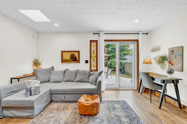 606 S 9th St, Columbus, OH 43206 - living area with a skylight, wood finished floors, a textured ceiling, and recessed lighting