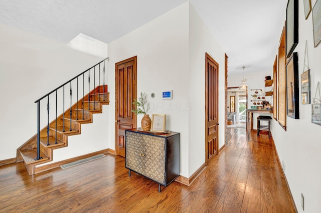 606 S 9th St, Columbus, OH 43206 - hallway featuring hardwood / wood-style flooring, stairway, and baseboards