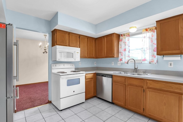 255 Oakview Ct, Pickerington, OH 43147 - kitchen featuring appliances with stainless steel finishes, a sink, light countertops, brown cabinetry, and light tile patterned flooring