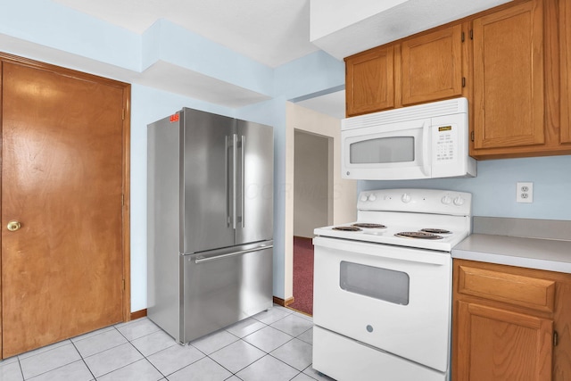 255 Oakview Ct, Pickerington, OH 43147 - kitchen featuring white appliances, light countertops, brown cabinets, and light tile patterned floors