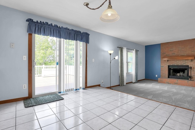255 Oakview Ct, Pickerington, OH 43147 - unfurnished living room with light tile patterned flooring, baseboards, a brick fireplace, and light carpet