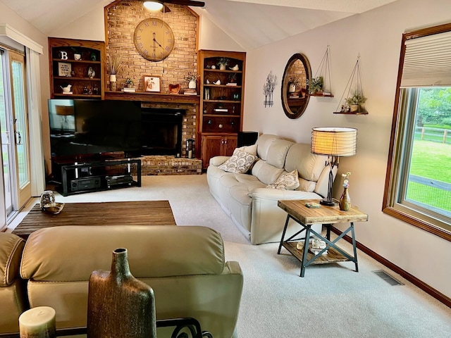 living room featuring vaulted ceiling, carpet floors, a fireplace, baseboards, and built in shelves
