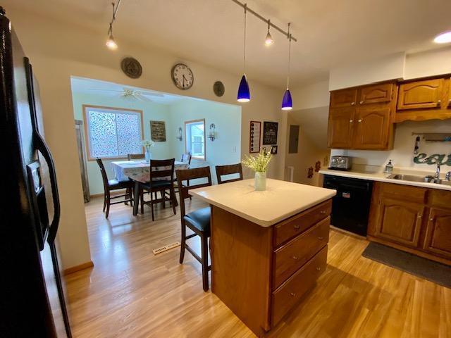 281 Bexford Rd, West Jefferson, OH 43162 - kitchen with rail lighting, black appliances, a sink, and light countertops