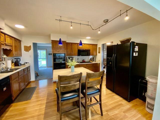 281 Bexford Rd, West Jefferson, OH 43162 - kitchen featuring black appliances, a sink, track lighting, and light wood-style flooring