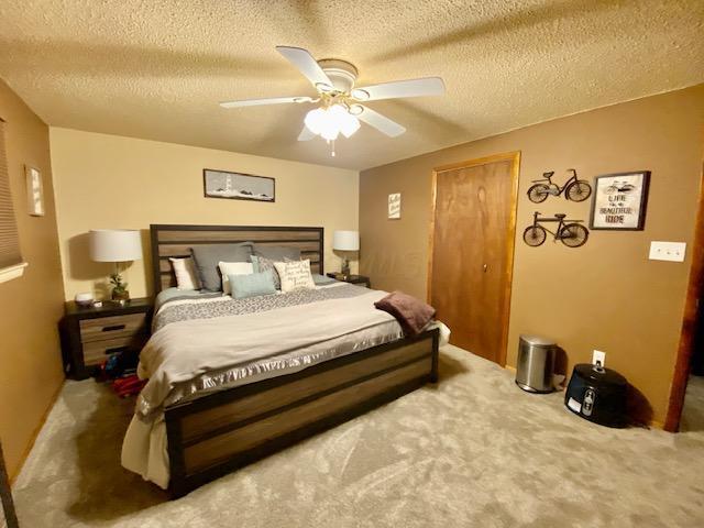 281 Bexford Rd, West Jefferson, OH 43162 - carpeted bedroom with a textured ceiling, a ceiling fan, and a closet