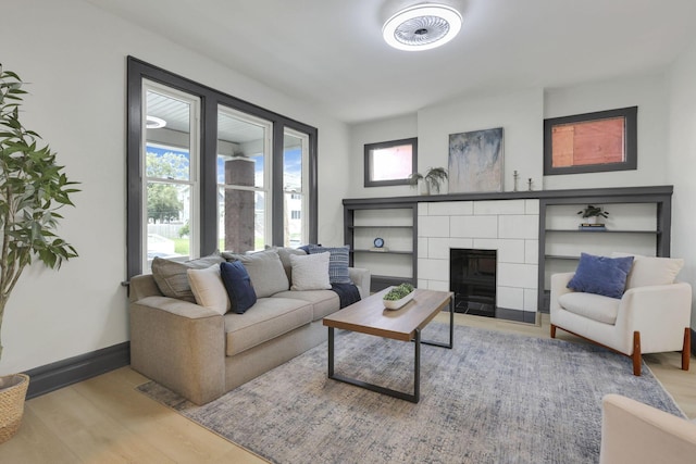 1195 E Whittier St, Columbus, OH 43206 - living area with wood finished floors, baseboards, and a tiled fireplace