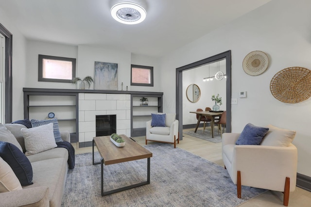 1195 E Whittier St, Columbus, OH 43206 - living area featuring a tile fireplace, wood finished floors, and baseboards