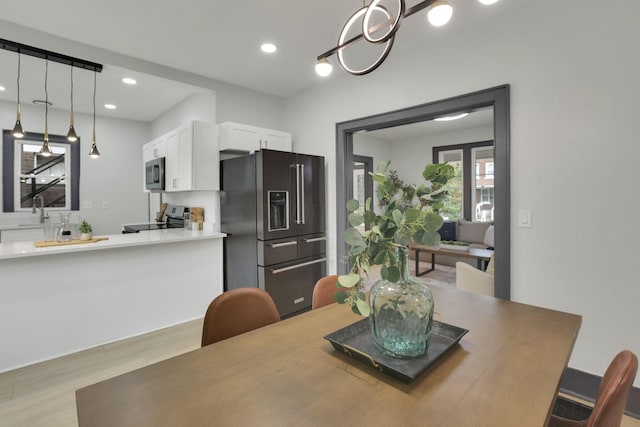 1195 E Whittier St, Columbus, OH 43206 - dining area featuring light wood-style floors, recessed lighting, and a chandelier