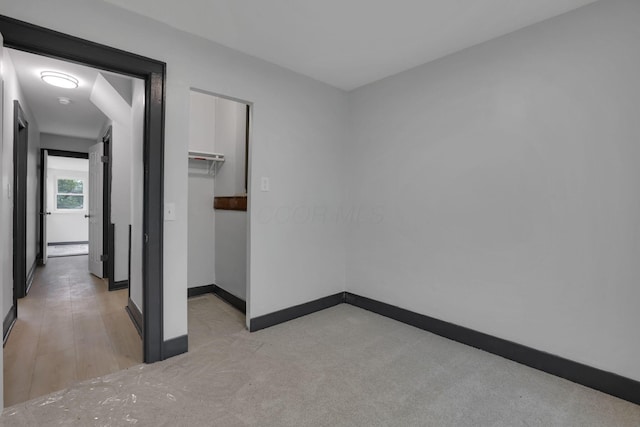 1195 E Whittier St, Columbus, OH 43206 - unfurnished bedroom with a walk in closet, baseboards, and a closet