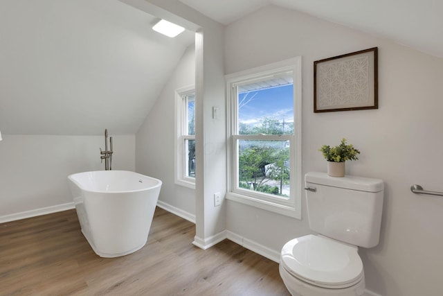 1195 E Whittier St, Columbus, OH 43206 - full bath featuring a freestanding tub, lofted ceiling, toilet, wood finished floors, and baseboards
