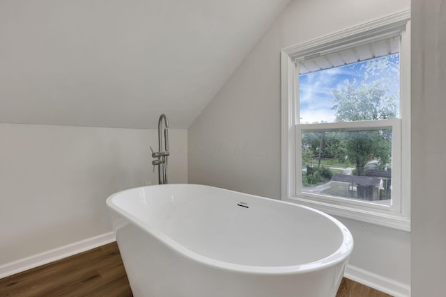 1195 E Whittier St, Columbus, OH 43206 - full bath featuring wood finished floors, vaulted ceiling, baseboards, and a freestanding tub