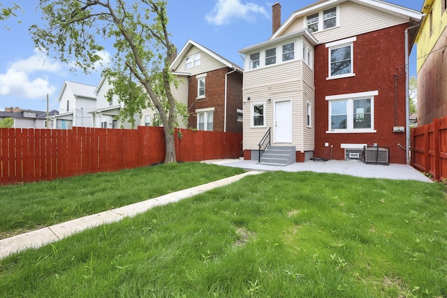1195 E Whittier St, Columbus, OH 43206 - view of front of house with entry steps, a chimney, a patio area, central AC, and brick siding