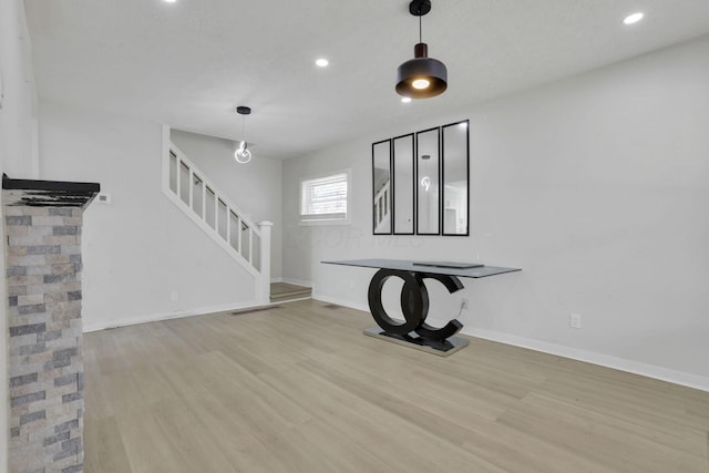 841 Saint Clair Ave, Columbus, OH 43201 - unfurnished living room featuring stairs, wood finished floors, baseboards, and recessed lighting