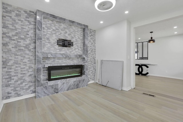 841 Saint Clair Ave, Columbus, OH 43201 - unfurnished living room featuring wood finished floors, baseboards, recessed lighting, and a glass covered fireplace