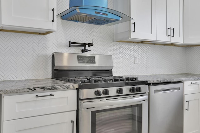 841 Saint Clair Ave, Columbus, OH 43201 - kitchen with range hood, stainless steel appliances, backsplash, white cabinetry, and light stone countertops