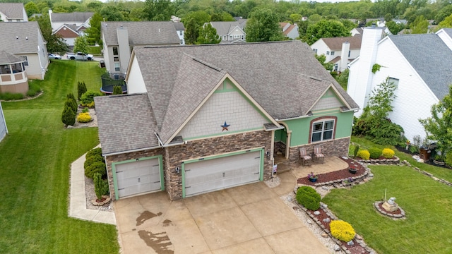 7563 Jenkins Dr, Canal Winchester, OH 43110 - view of front facade featuring stone siding, driveway, a garage, and a residential view