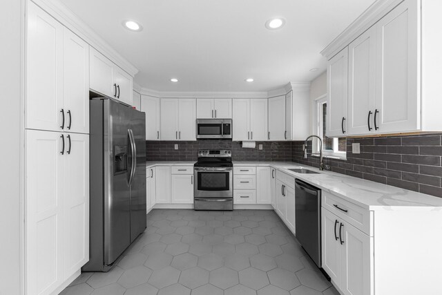 270 S Kellner Rd, Columbus, OH 43209 - kitchen featuring stainless steel appliances, a sink, light stone counters, backsplash, and recessed lighting