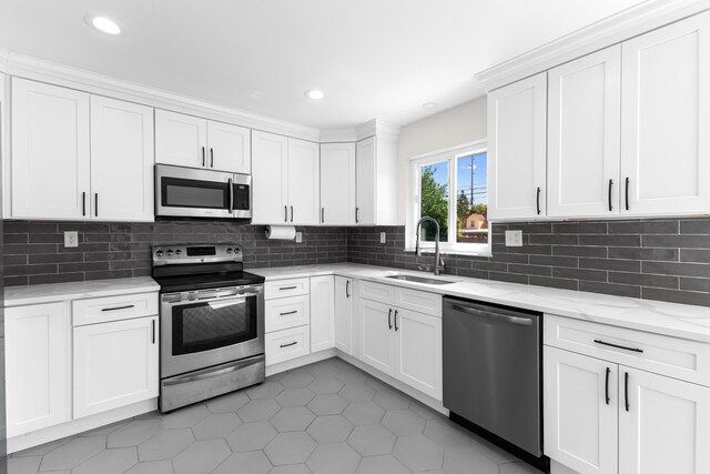 270 S Kellner Rd, Columbus, OH 43209 - kitchen with stainless steel appliances, a sink, white cabinetry, light tile patterned floors, and backsplash