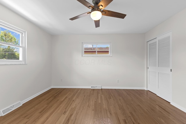 270 S Kellner Rd, Columbus, OH 43209 - unfurnished bedroom with multiple windows, light wood-style floors, baseboards, and a closet
