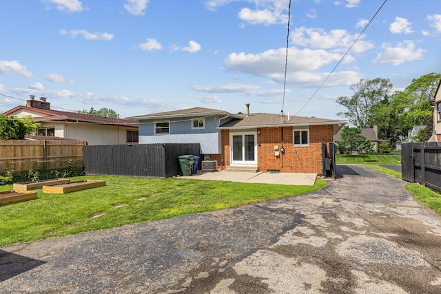 270 S Kellner Rd, Columbus, OH 43209 - back of property with a vegetable garden, brick siding, a patio, cooling unit, and a shingled roof