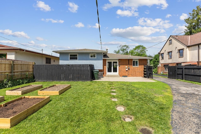 270 S Kellner Rd, Columbus, OH 43209 - rear view of property featuring a vegetable garden, a patio, and brick siding