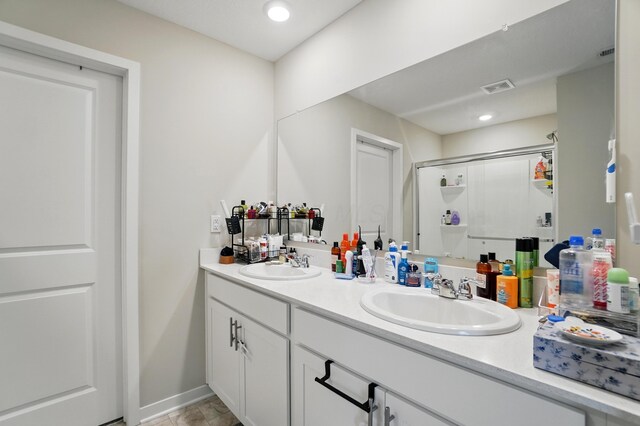 314 Sandburg Dr, Lithopolis, OH 43136 - bathroom featuring a stall shower, double vanity, baseboards, and recessed lighting