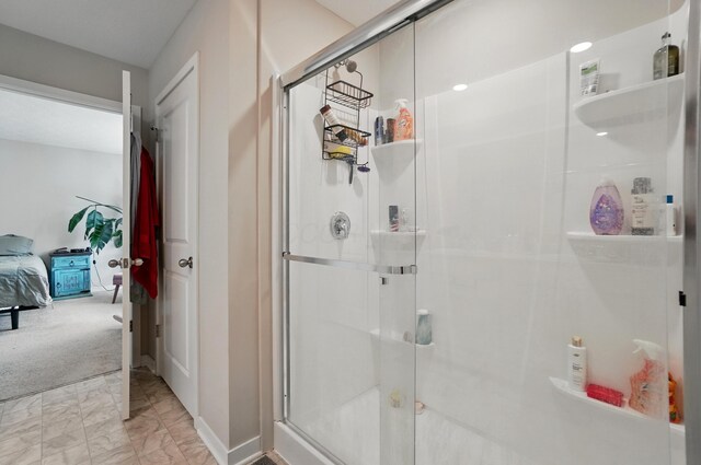 314 Sandburg Dr, Lithopolis, OH 43136 - bathroom featuring connected bathroom, marble look tile flooring, a shower stall, and baseboards