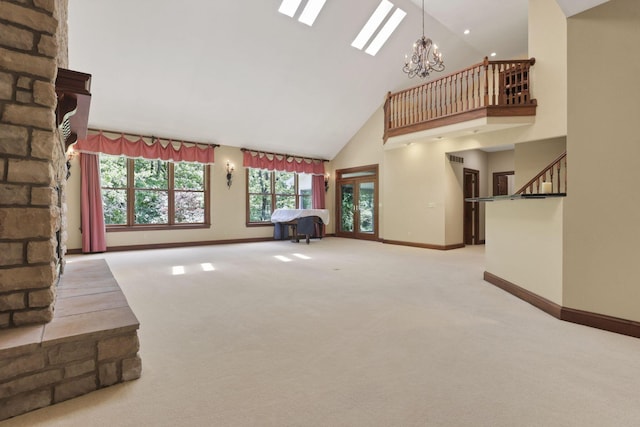 1200 Willow Rd, Springfield, OH 45502 - unfurnished living room featuring high vaulted ceiling, baseboards, light carpet, a chandelier, and stairway