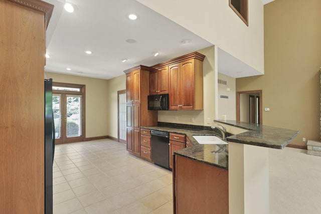 1200 Willow Rd, Springfield, OH 45502 - kitchen featuring black appliances, a sink, a peninsula, dark stone counters, and recessed lighting