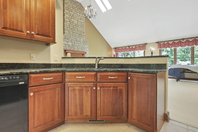 1200 Willow Rd, Springfield, OH 45502 - kitchen featuring dishwasher, dark stone countertops, vaulted ceiling, a skylight, and a peninsula