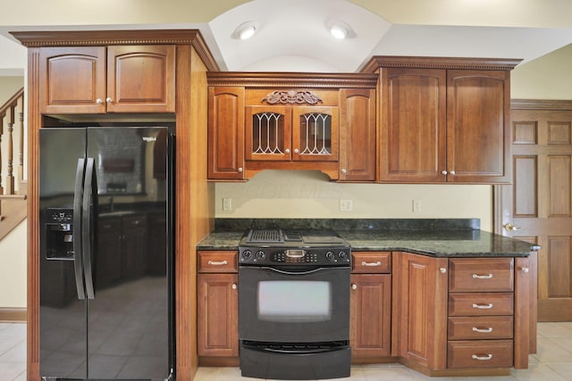 1200 Willow Rd, Springfield, OH 45502 - kitchen with black appliances, dark stone countertops, light tile patterned floors, and brown cabinets