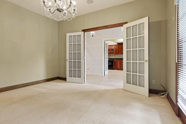 1200 Willow Rd, Springfield, OH 45502 - unfurnished room with french doors, light colored carpet, a chandelier, and baseboards