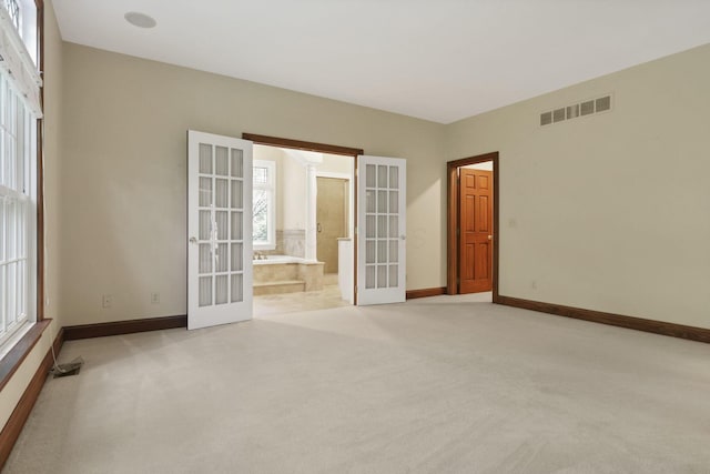 1200 Willow Rd, Springfield, OH 45502 - unfurnished room with french doors, light colored carpet, baseboards, and plenty of natural light