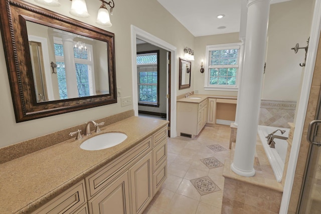 1200 Willow Rd, Springfield, OH 45502 - bathroom with ornate columns, two vanities, a garden tub, and tile patterned flooring