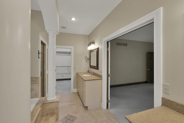 1200 Willow Rd, Springfield, OH 45502 - bathroom with ornate columns, vanity, recessed lighting, baseboards, and a spacious closet