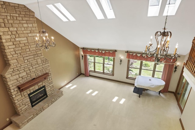 1200 Willow Rd, Springfield, OH 45502 - unfurnished living room with a skylight, a chandelier, baseboards, a fireplace, and carpet