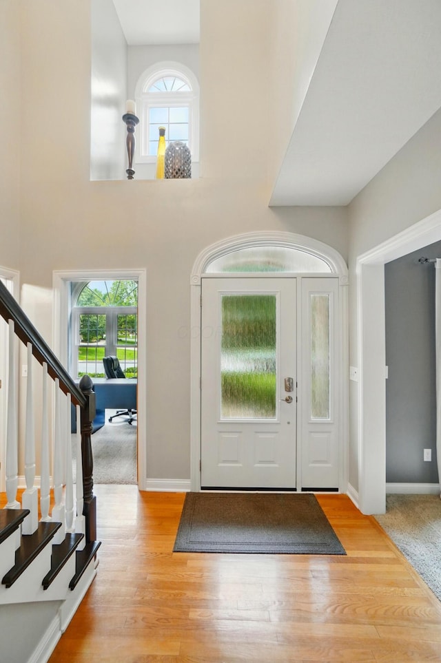 5741 Ridgewood Ave, Westerville, OH 43082 - foyer with stairway, healthy amount of natural light, baseboards, and wood finished floors