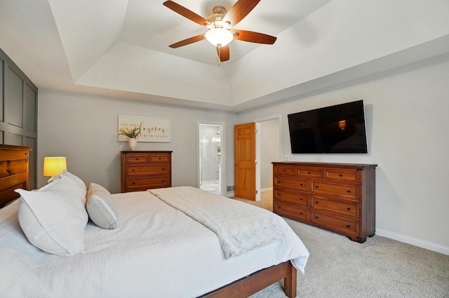 5741 Ridgewood Ave, Westerville, OH 43082 - bedroom with light carpet, a raised ceiling, baseboards, ensuite bathroom, and a ceiling fan