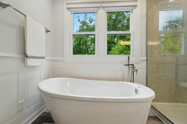 5741 Ridgewood Ave, Westerville, OH 43082 - full bathroom with a decorative wall, a freestanding tub, a wainscoted wall, and a shower