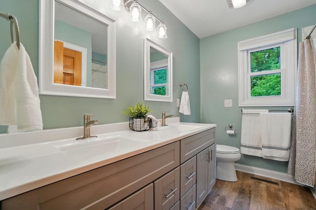 5741 Ridgewood Ave, Westerville, OH 43082 - bathroom with double vanity, wood finished floors, toilet, baseboards, and a shower with curtain