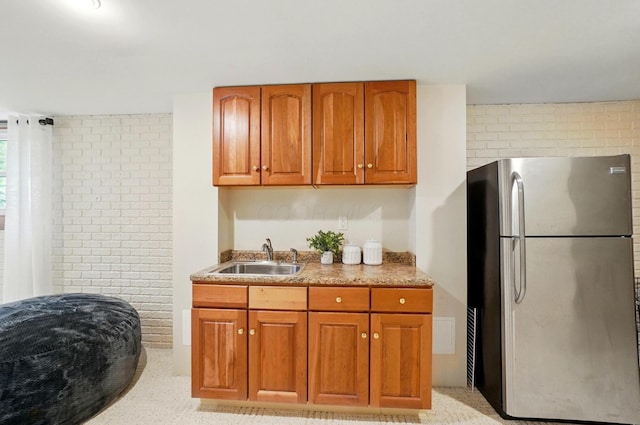 5741 Ridgewood Ave, Westerville, OH 43082 - kitchen featuring freestanding refrigerator, a sink, and brown cabinetry