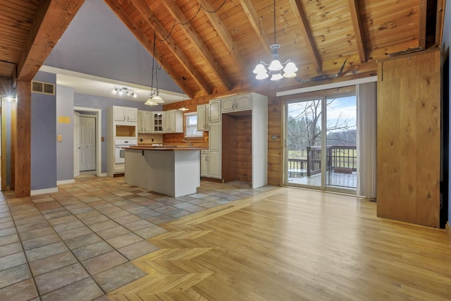 7760 Township Rd 177, Fredericktown, OH 43019 - kitchen with wooden ceiling with exposed beams, white oven, white cabinets, glass insert cabinets, and a chandelier