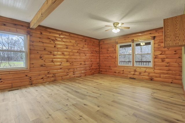 7760 Township Rd 177, Fredericktown, OH 43019 - spare room featuring wood finished floors, ceiling fan, plenty of natural light, beamed ceiling, and a textured ceiling