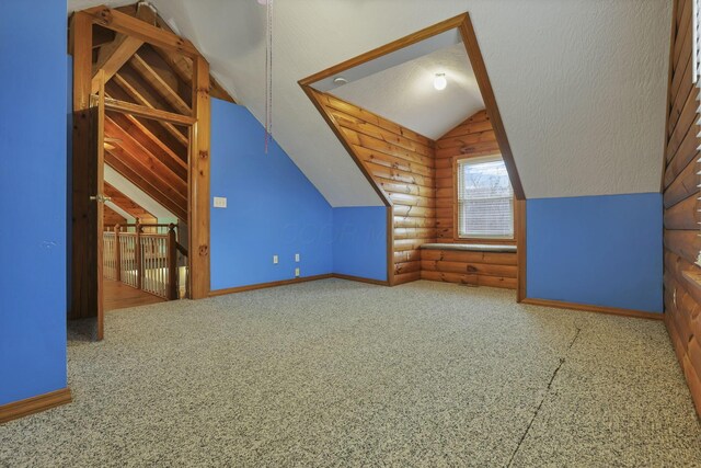 7760 Township Rd 177, Fredericktown, OH 43019 - additional living space featuring log walls, vaulted ceiling, and baseboards