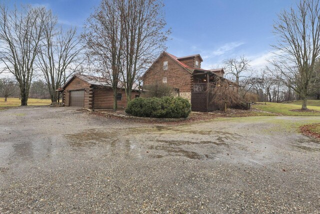 7760 Township Rd 177, Fredericktown, OH 43019 - view of side of property with log siding, an outdoor structure, and driveway