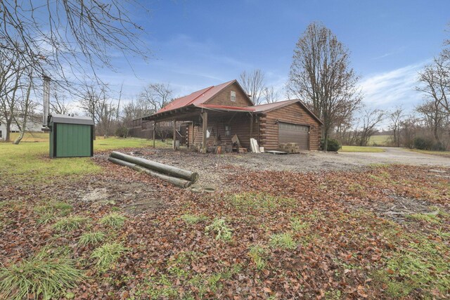 7760 Township Rd 177, Fredericktown, OH 43019 - view of side of home featuring log siding and metal roof