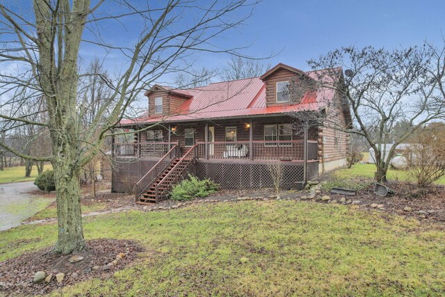 7760 Township Rd 177, Fredericktown, OH 43019 - log-style house featuring log exterior, covered porch, a front lawn, and stairs